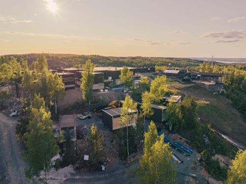an aerial view of a building with trees in the foreground at Panorama Landscape Hotel in Nilsiä