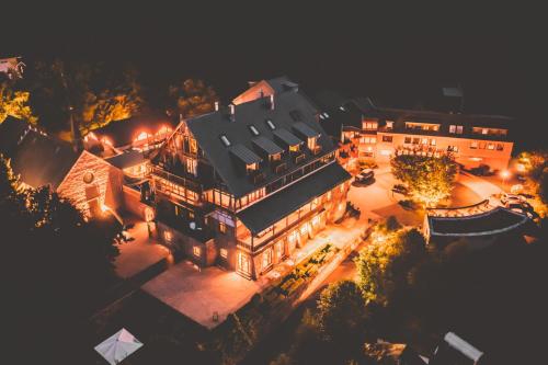 an aerial view of a large house at night at Marienhöh - Hideaway & Spa in Langweiler