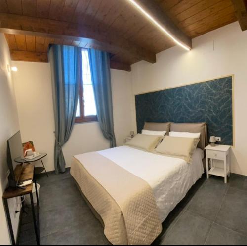 a bedroom with a large bed and a window at Casa Raffaela in Marina di Pisa