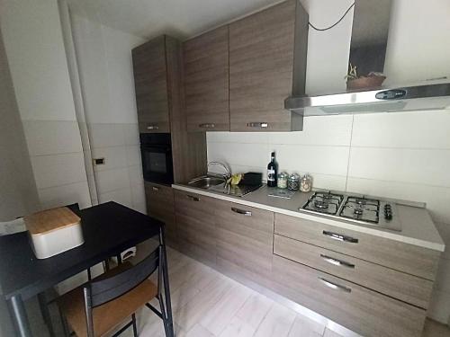 a kitchen with wooden cabinets and a black counter top at Casa Tatone in Roccaraso