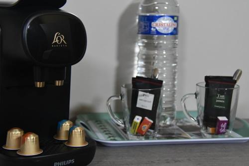 a coffee maker and two cups on a tray at La maison des collines in Allemagne-en-Provence