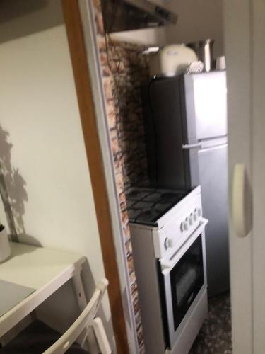 una piccola cucina con piano cottura e frigorifero di CASA PICCOLA LELLA a Policoro