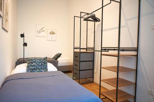 a bedroom with a bed and a glass closet at Trendy Apartment 3 Zimmer zentral gelegen in Vienna