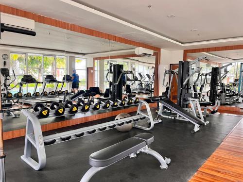 a gym with several treadmills and tread machines at VidaView Apart for Family Syariah by NAD in Pampang
