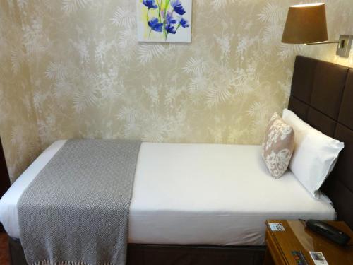 Postel nebo postele na pokoji v ubytování Hotel Lloret Ramblas