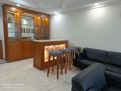 een woonkamer met een bank en een open haard bij Dynamic Room(R3) Embellished with Excellence-Heart of City in New Delhi