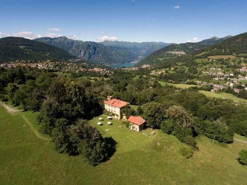 an aerial view of a house in a field with trees at Hotel Villa Simplicitas in San Fedele Intelvi