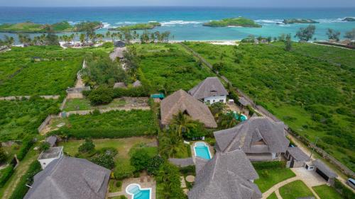 an aerial view of a house with the ocean in the background at Nyumba ya Afrika in Watamu