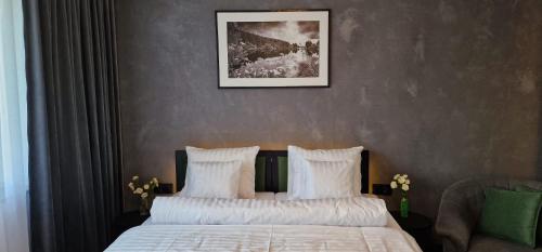 a bedroom with two beds and a picture on the wall at Apartamenty Rzucewska 87 in Żelistrzewo