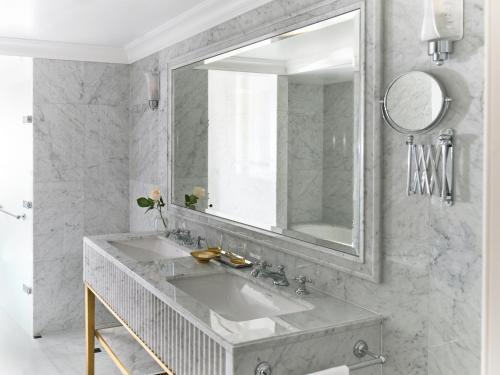 a bathroom with a sink and a mirror at The Dorchester - Dorchester Collection in London