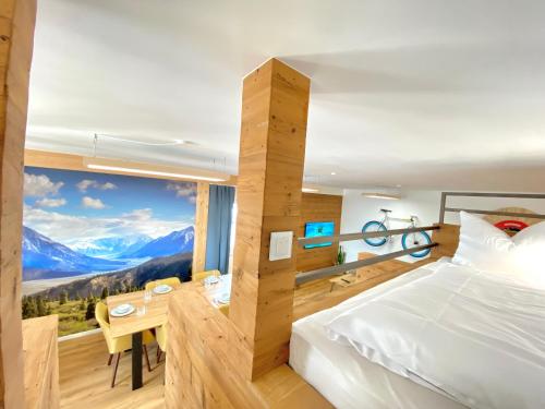 a bedroom with a bed and a table with a view at Best Butler Active Alpin Hund Küche Parken in Füssen