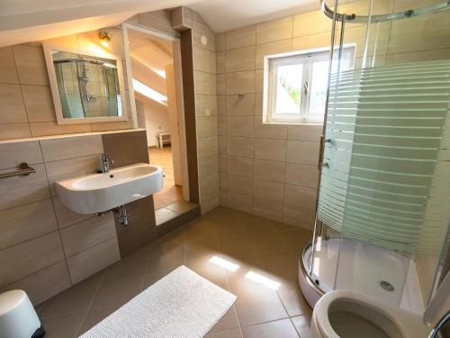 a bathroom with a toilet and a sink and a shower at Anka in Banjol