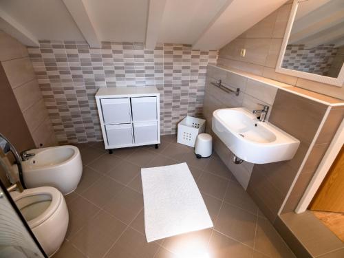 a bathroom with a toilet and a sink at Anka in Banjol