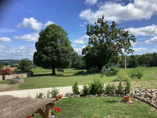 a view of a garden with trees and grass at Chez Goret Gites - Gite Skippy Couples only in Courgeac