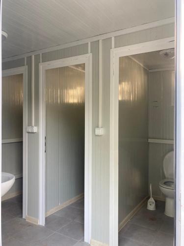 a bathroom with a toilet and a sink at Divoto Glamping in Balchik