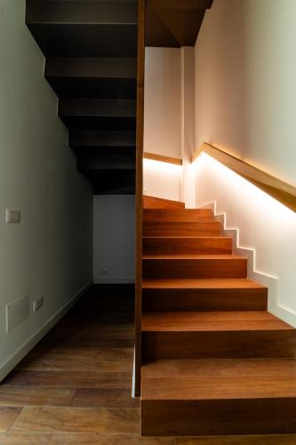 a staircase in a room with wood floors at Arringo - Stay comfy in Conversano