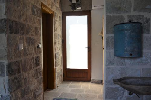 a room with a door and a window and a sink at Markovic Winery and Estate apartments in Cetinje