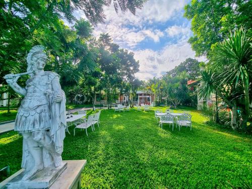 a statue of a woman standing in a park at Best Way Resort in Pak Chong