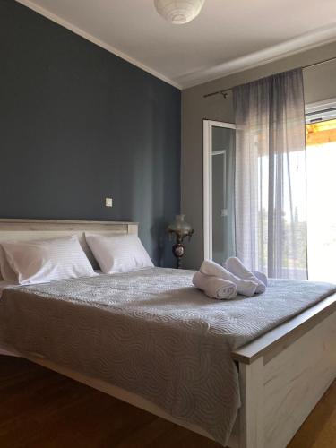 a bedroom with a large bed with two towels on it at Olive Garden House in Ágios Prokópios