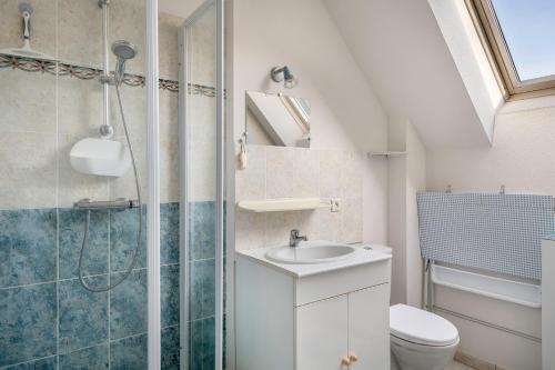 uma casa de banho com um chuveiro, um WC e um lavatório. em Maison confortable et familiale pour 6 personnes em Sarzeau