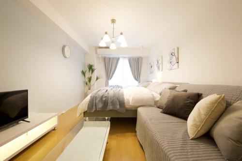 a living room with a couch and a bed at Generous Forest 201 in Tokyo