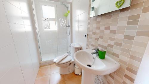 a bathroom with a sink and a toilet at Casa Mandolina - A Murcia Holiday Rentals Property in Murcia