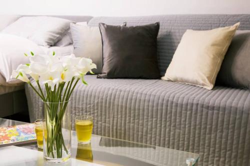 a vase of flowers sitting on a table next to a couch at Generous Forest 201 in Tokyo