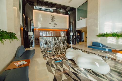 a lobby with chairs and a wall of wine glasses at Sunshine Apartments Batumi Lux in Batumi