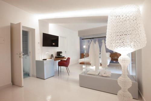 a white living room with a large white light fixture at Aquamaris Design Suite & Spa in Paestum