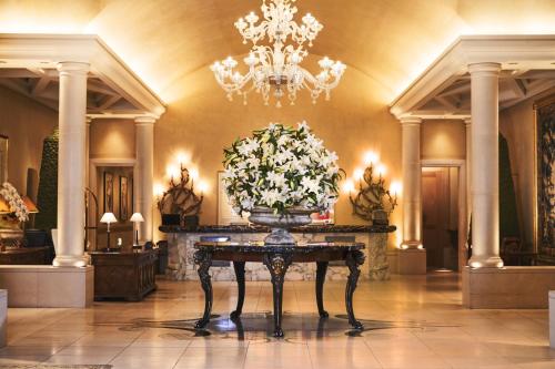 a lobby with a vase of flowers on a table at Hotel Hankyu International in Osaka