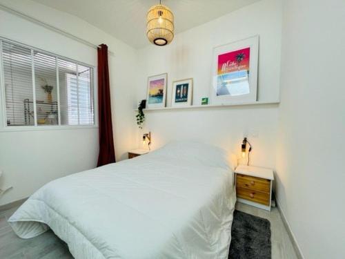une chambre blanche avec un lit et une fenêtre dans l'établissement Maison rénovée T2 50m² - 4 pers - Proche côte sauvage - Jardin - Parking - Quartier calme - FR-1-478-260, à Saint-Pierre-Quiberon