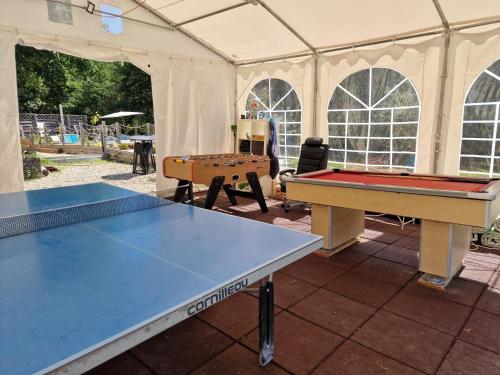 two ping pong tables in a tent at La Forestine in Bergerac