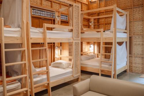 a room with a bunch of bunk beds at Society House Luxury Hostel in Pai