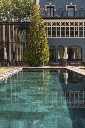 a swimming pool in front of a building at Balneario Font Vella- Adults Only in Sant Hilari Sacalm