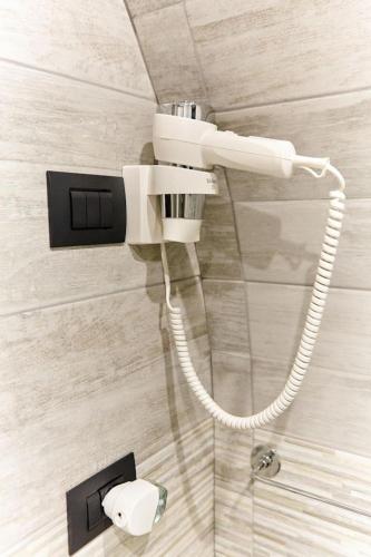 a shower with a cord hanging from a wall at Stefano's house in Catania