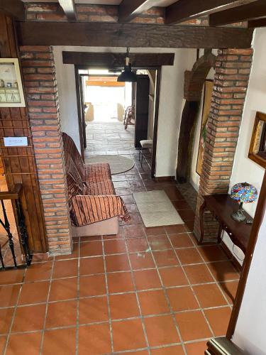 a living room with a couch and a tile floor at Posada El Valle - Adults Only in Suances