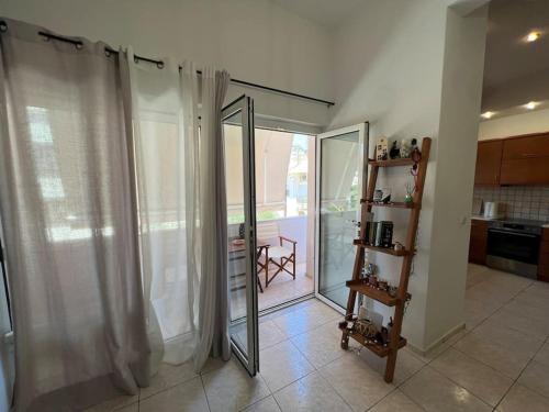 a kitchen with a sliding glass door to a balcony at Minimalist Flat with Balcony in Heraklio Town