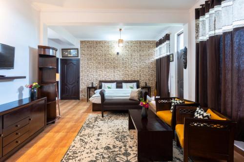 a living room with a couch and a bed at Poetry by the Hills - House Of Hive, Ramgarh, Mukteshwar, Nainital in Rāmgarh