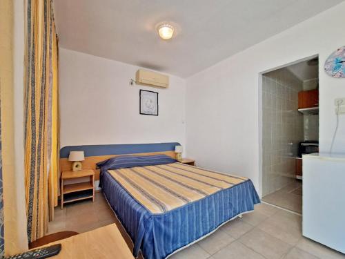 a small bedroom with a bed and a small table at Di Mare Holiday Village in Kranevo