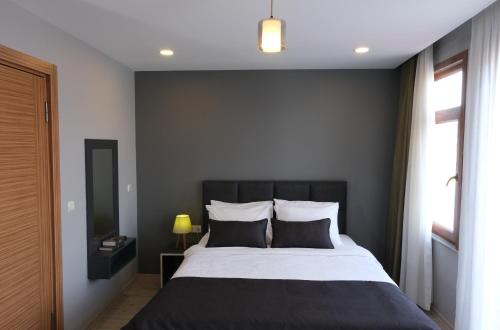 a bedroom with a black and white bed and a window at Ore Pera Suites in Istanbul