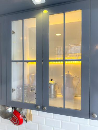 a blue cabinet with dishes and utensils in it at Armada Resort Puncak in Sampal 2