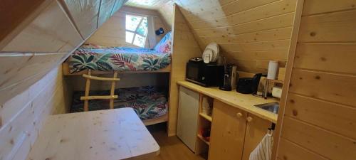 a tiny house with a sink and a bed in it at Cabane Féerique in Laives