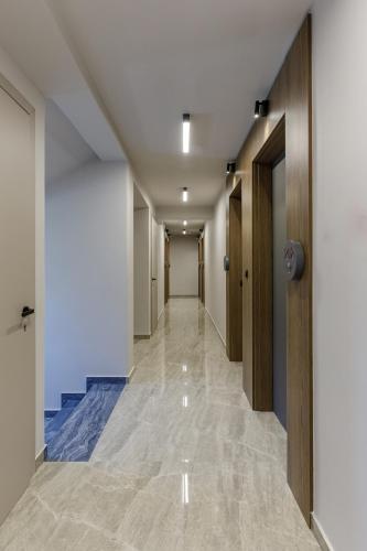 a hallway of an office building with a long corridor at Costa De Luxe Suites in Leptokaria