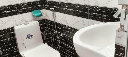 a bathroom with a toilet and a sink at Nepalaya Home Hostel in Kathmandu