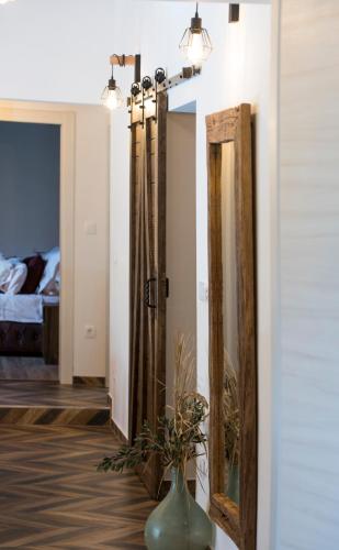 a room with two mirrors and a vase on a table at Luxury Villa Nature with heated private pool, sauna & fire pit, a short walk to the beach in Milna