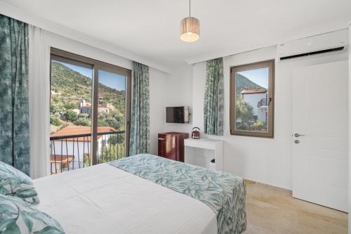 a bedroom with a bed and a balcony at Bal Butik Otel in Datca