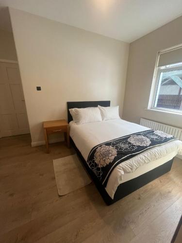 a bedroom with a bed and a window at Yeats Lodge Self catering Apartment and Bar in Galway
