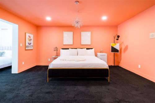 a bedroom with orange walls and a large bed at The Palmcroft in Scottsdale