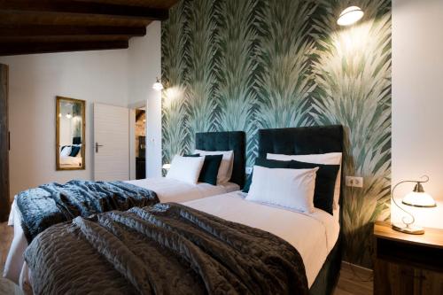 a bedroom with two beds and a wall mural at Luxury Villa Nature with heated private pool, sauna & fire pit in Milna