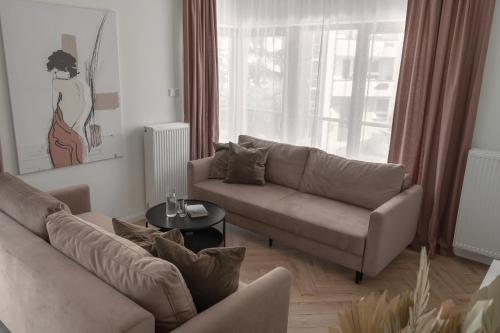 a living room with a couch and a table at APARTIO ROOMS Gliwice in Gliwice